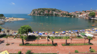 Beach crowded umbrellas hill town - a hill in the background free wallpaper