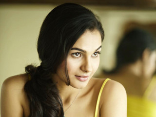 Woman yellow top serious look - her face and shoulder free wallpaper
