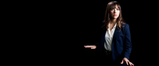 Woman suit serious hands out - her free wallpaper