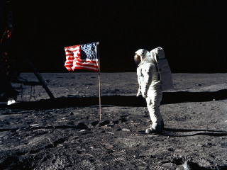 Astronaut standing moon flag surface - a flag in the background free wallpaper