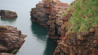 Water rocky cliffs grass hills - a few boat free wallpaper