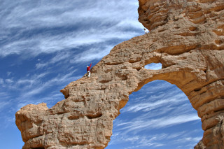 Person standing rock formation sky - amir zand free wallpaper