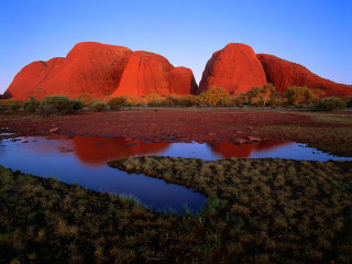 Large rock formation lake grassy - a grassy area in front free wallpaper