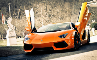 Orange sports car parked street - the car free wallpaper