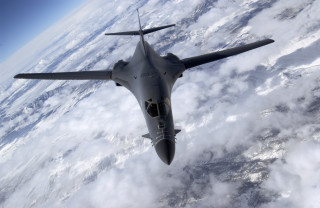 Fighter jet flying over clouds - douglas shuler free wallpaper