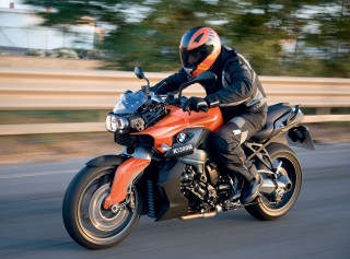 Motorcycle rider fence trees blurry - a blurry background free wallpaper