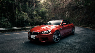 Red car parked road forest - a red car free wallpaper