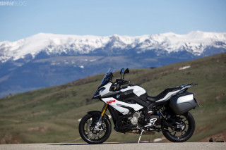 Motorcycle parked road mountains snow - constant permeke free wallpaper