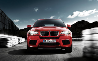 Red car driving street building 6 - a red car free wallpaper