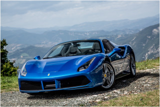 Blue sports car rocky road - a view of the valley below free wallpaper