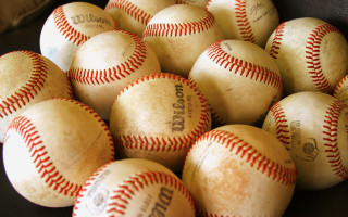 Baseballs pile table glove background - free sports wallpaper