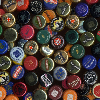 Colorful bottle caps black background - a tilt shift photo free wallpaper