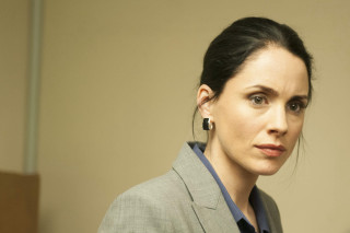 Woman suit earrings serious look - her face and shoulder free wallpaper