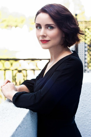 Woman arms crossed leaning wall 2 - modernism free wallpaper