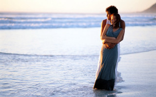 Man woman embracing beach sunset - romantic free wallpaper