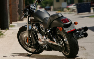 Black motorcycle parked road building - dan scott free wallpaper