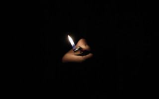 Person holding lighter dark background 2 - a lighter free wallpaper