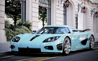 Blue sports car lightblue building - the side of the road in front free wallpaper
