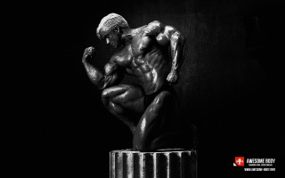 Statue man sitting pedestal dark - a statue of a man free wallpaper