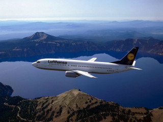 Jetliner flying mountains lake sky - a large jetliner free wallpaper for desktop