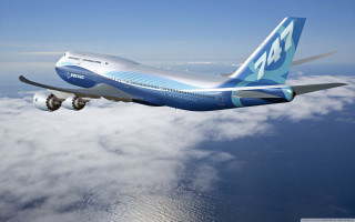 Large jetliner blue sky clouds 5 - international typographic style free wallpaper