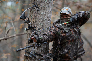 Man holding bow aiming arrow 2 - live action free wallpaper