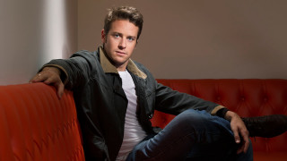 Man sitting red couch arms - a red couch free wallpaper