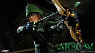 Woman green bow arrow dark - a wooden wall behind her free wallpaper