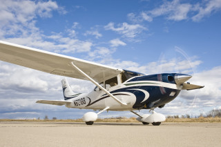 Small airplane runway blue sky - a few white cloud free wallpaper