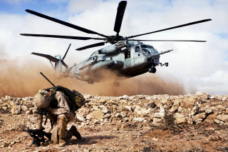 Helicopter rocky terrain man walking - action scene free wallpaper