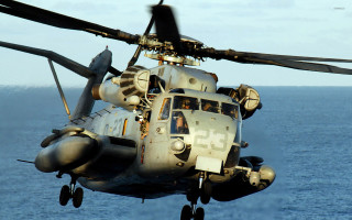 Military helicopter flying ocean sunny - a propeller free wallpaper