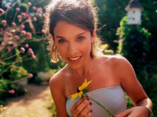 Woman holding flower smiling house - a flower free wallpaper