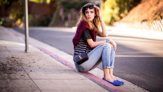 Woman sitting road street sign - colorful accent free wallpaper