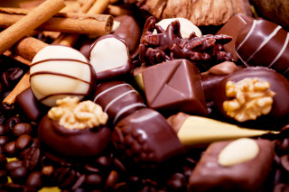 Chocolates nuts cinnamon sticks table - food photography free wallpaper