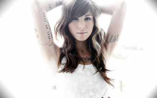Fantastically beautiful tattooed woman wind - her hand behind her head free wallpaper