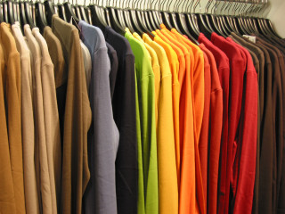 Rack of shirts and pants - a silk screen free wallpaper