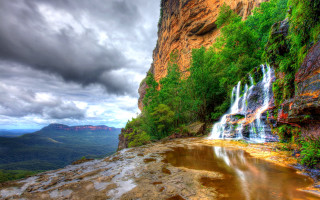 Waterfall cascading valley mountain background - bob thompson free wallpaper