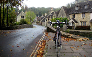 Bicycle parked road houses hill - the side of a road next free wallpaper