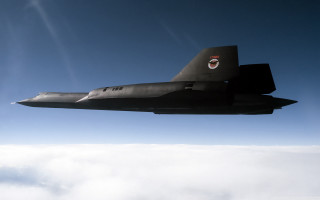 Military jet flying blue sky 3 - cloud below free wallpaper