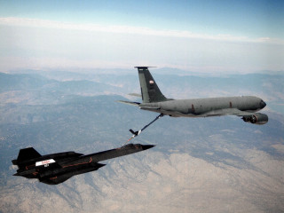 Jet loading missile fighter jet - a mountain range in the background free wallpaper