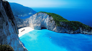 Beach rock formation boat water 2 - a large rock formation in the middle of it free wallpaper