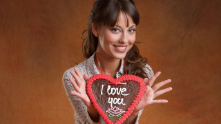 Woman holding heart cake i - it in front free wallpaper