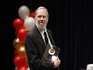 Man suit holding plaque stage - peter konig free wallpaper