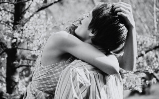 Woman hugging head forest blurry - free love wallpaper
