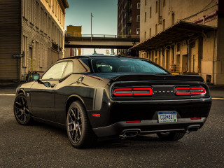 Black sports car city street - a bridge in the background free wallpaper