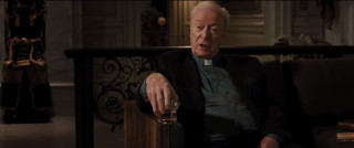 Man priest outfit holding glass - institutional critique free wallpaper