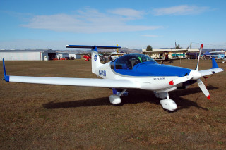 Small airplane grass field building 2 - front view free wallpaper