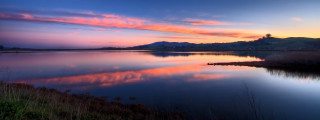 Lake sunset mountain pink sky 2 - a sunset in the background and a mountain in the distance free wallpaper