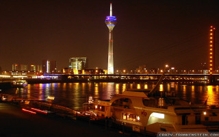 City skyline night river boats - amir zand free wallpaper