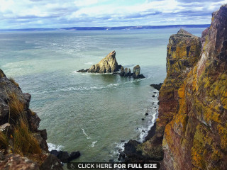 Rocky cliff ocean rock formation - a rocky cliff free wallpaper